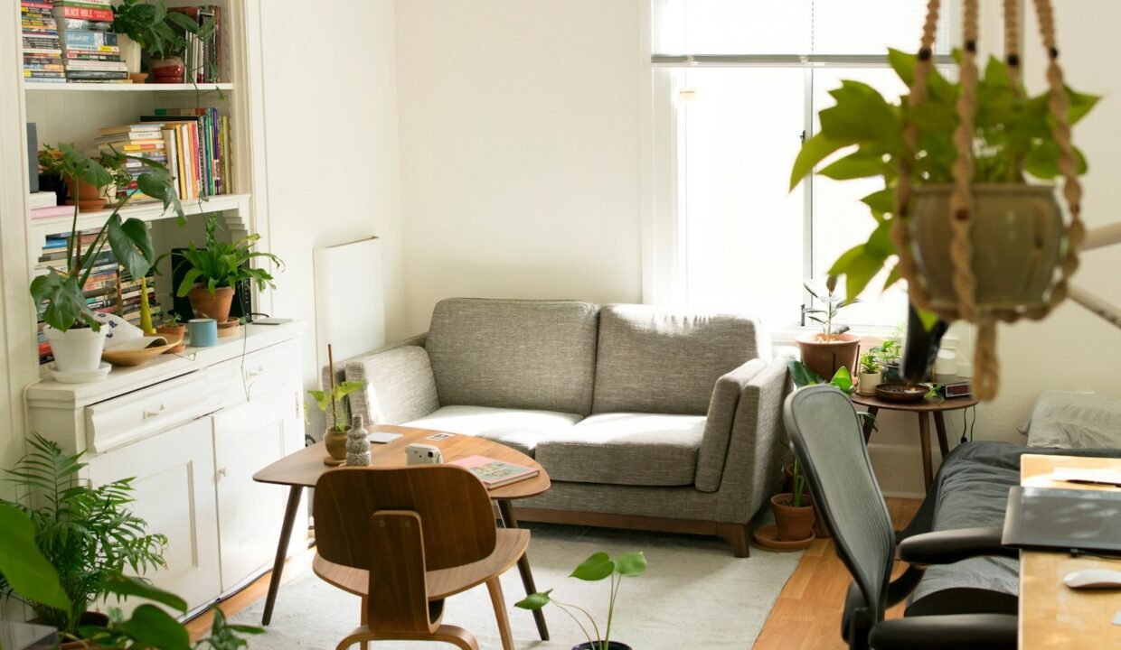 gray fabric loveseat near brown wooden table